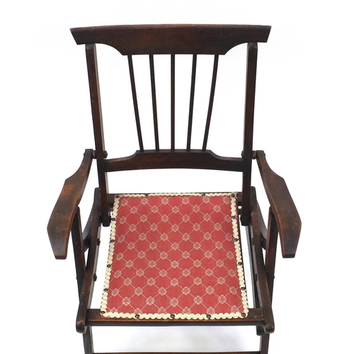 79 - Folding mahogany campaign chair with salmon upholstered seat, 80cm high