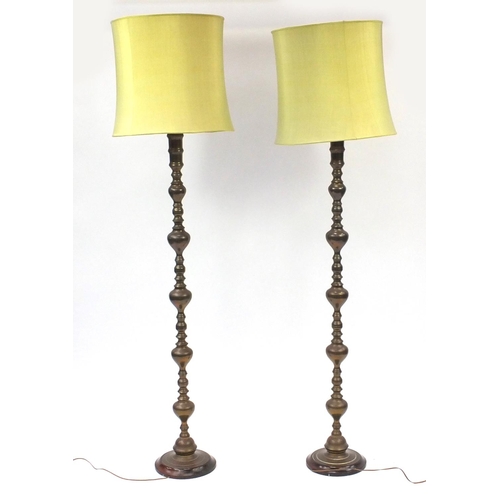 70 - Pair of bronzed metal standard lamps with shades, each 189cm high