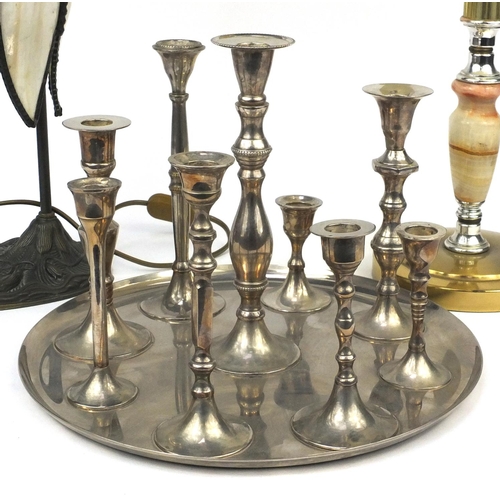 565 - Tiffany style tulip lamp, onyx and brass lamp and a set of white metal candlesticks on tray