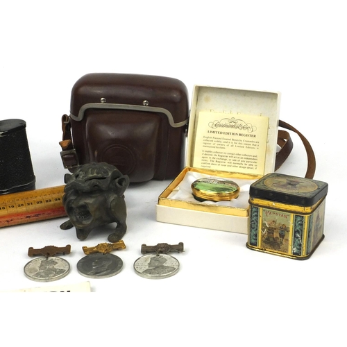 306 - Box of items including binoculars, camera, grotesque inkwell, enamel pill box etc