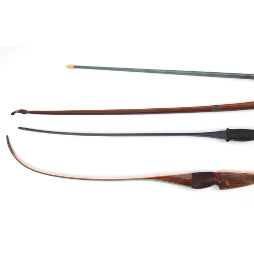 766 - Four vintage longbows including Yeoman, Ben Pearson and Paul Bunyan examples