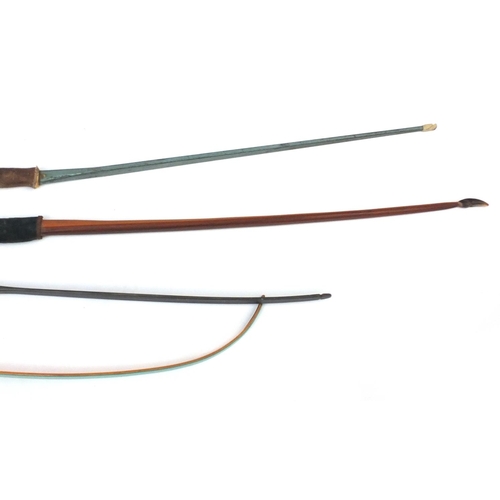 766 - Four vintage longbows including Yeoman, Ben Pearson and Paul Bunyan examples