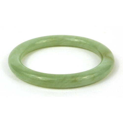 350 - Chinese green jadeite bangle, 8.5cm in diameter, approximate weight  50.6g