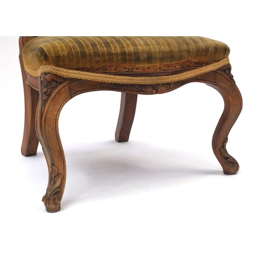 21 - Carved walnut nursing chair with gold striped upholstery, 90cm high