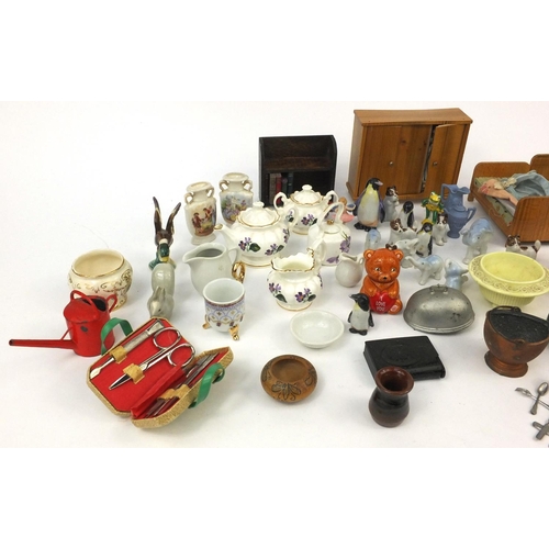 570 - Selection of wooden dolls house furniture, porcelain dolls house tea services and other dolls house ... 