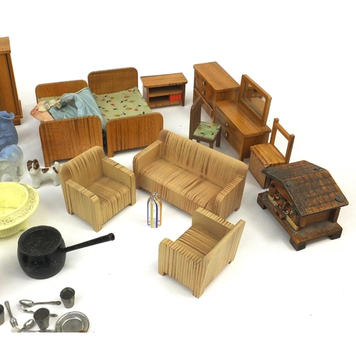 570 - Selection of wooden dolls house furniture, porcelain dolls house tea services and other dolls house ... 