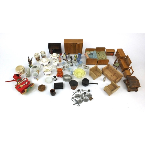 570 - Selection of wooden dolls house furniture, porcelain dolls house tea services and other dolls house ... 