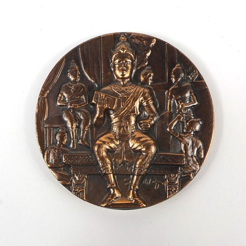 705 - Thai bronzed medallion depicting Buddha's, housed in a case