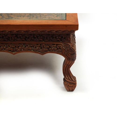 2024 - Rectangular Indonesian hardwood coffee table carved with flowers and foliage, 42.5cm high x 153cm wi... 