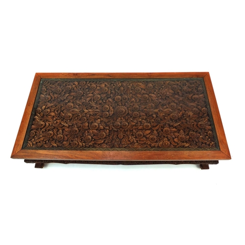 2024 - Rectangular Indonesian hardwood coffee table carved with flowers and foliage, 42.5cm high x 153cm wi... 