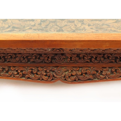 2024 - Rectangular Indonesian hardwood coffee table carved with flowers and foliage, 42.5cm high x 153cm wi... 