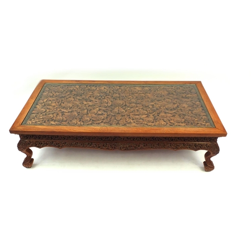 2024 - Rectangular Indonesian hardwood coffee table carved with flowers and foliage, 42.5cm high x 153cm wi... 