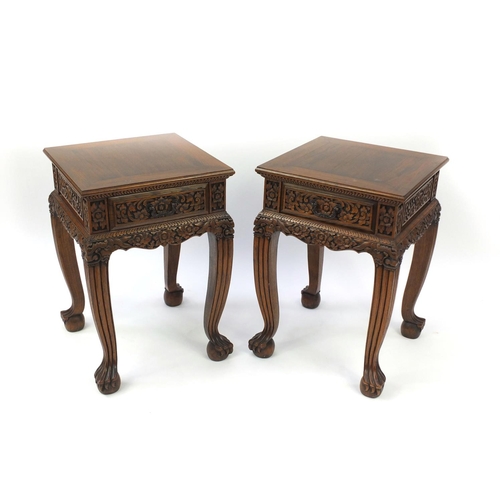 2023 - Pair of Indonesian hardwood side tables, each with a frieze drawer and carved with flowers and folia... 