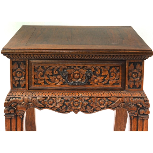 2023 - Pair of Indonesian hardwood side tables, each with a frieze drawer and carved with flowers and folia... 