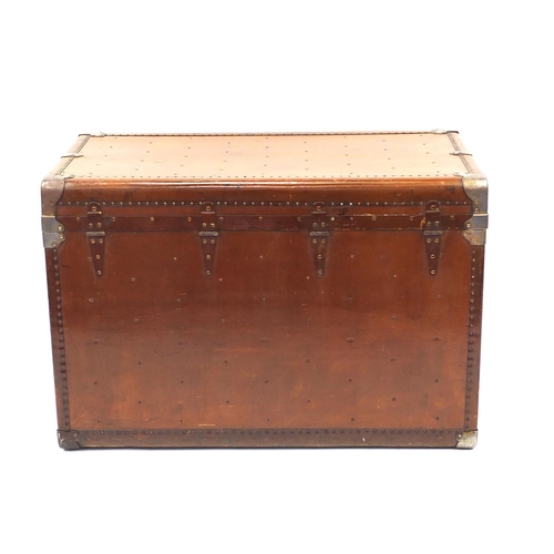 2044 - Vintage travelling trunk with part labels and Terryville USA lock, 67cm high x 97cm wide x 55cm deep