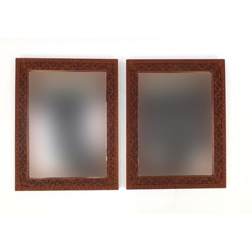 2020 - Pair of ornate Thai hardwood mirrors, each carved with foliage, each 66cm x 51cm