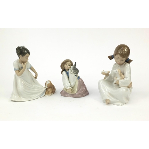 2068 - Three Nao figurines each of young girls with animals, all with boxes, each with factory marks to the... 