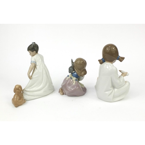 2068 - Three Nao figurines each of young girls with animals, all with boxes, each with factory marks to the... 