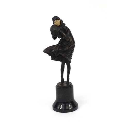 2093 - Bronze study of an Art Deco female wearing hand warmers, raised on a circular marble base, overall 3... 