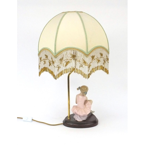 2079 - Porcelain ballerina  lamp raised on a wooden base with shade and beaded drops, overall 59cm high