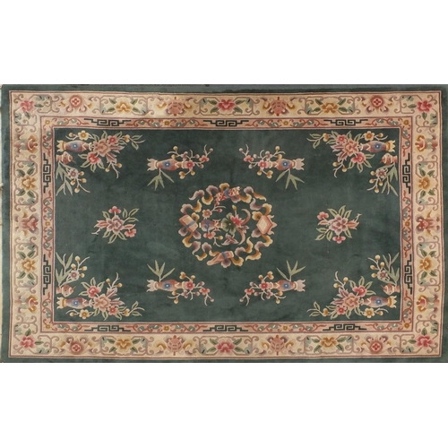 85 - Chinese super wash carpet with predominantly green ground and flowers in vases, approximately 340cm ... 