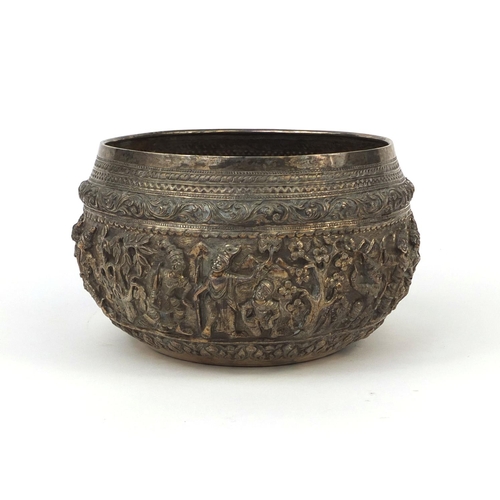 609 - Burmese silver bowl profusely embossed with figures amongst tress, within foliate boarders, stamp ma... 