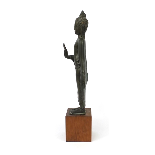 605 - Antique Thai patinated bronze standing figure of Buddha, on a later wooden stand, overall 61cm high