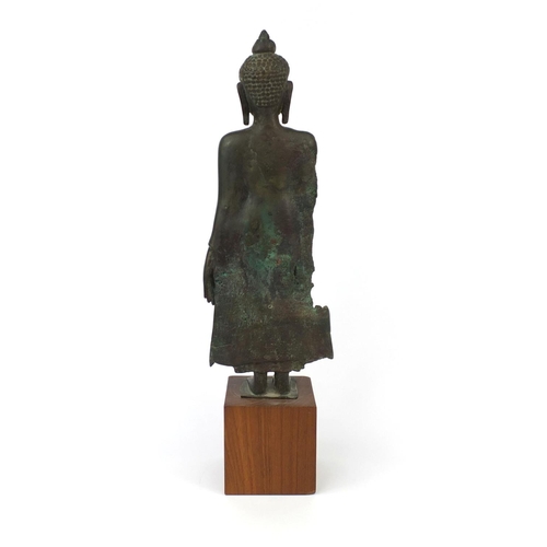 605 - Antique Thai patinated bronze standing figure of Buddha, on a later wooden stand, overall 61cm high