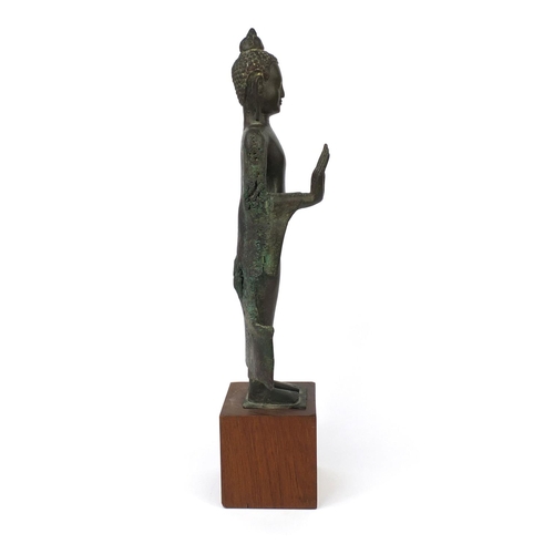 605 - Antique Thai patinated bronze standing figure of Buddha, on a later wooden stand, overall 61cm high