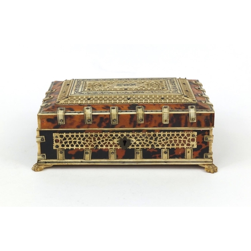 628 - 19th century Anglo Indian tortoiseshell and bone mounted casket, on paw feet, the pierced bone panel... 