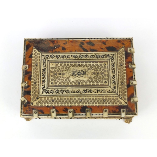 628 - 19th century Anglo Indian tortoiseshell and bone mounted casket, on paw feet, the pierced bone panel... 