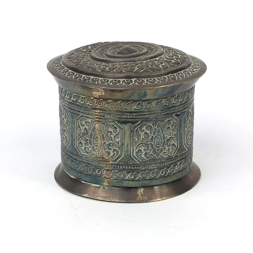 615 - Burmese silver cylindrical box and cover, embossed with floral motifs, 8.5cm high x 9.5cm in diamete... 