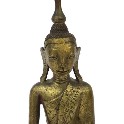 603 - Antique Thai bronze seated figure of Buddha, script to the reverse, 26cm high