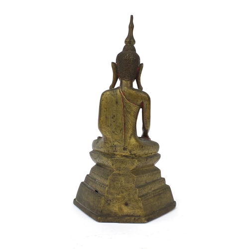 603 - Antique Thai bronze seated figure of Buddha, script to the reverse, 26cm high