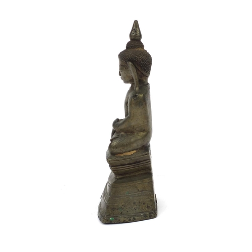 604 - Antique Thai patinated bronze seated figure of Buddha, script to the reverse, 18.5cm high