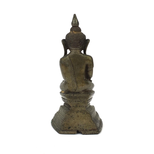 604 - Antique Thai patinated bronze seated figure of Buddha, script to the reverse, 18.5cm high