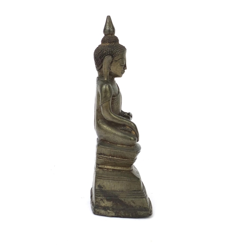 604 - Antique Thai patinated bronze seated figure of Buddha, script to the reverse, 18.5cm high