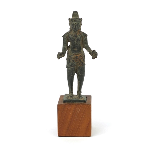 607 - Antique Thai Bronze figure raised on a later wooden base, overall 15.5cm high