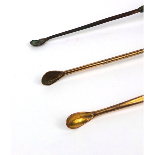 107 - Three glass handled ear scoops each with brass scoop, the largest 16.5cm in length