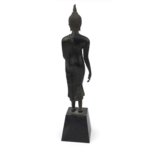 606 - Thai patinated bronze standing figure of Buddha, on wooden stand, overall 68cm high