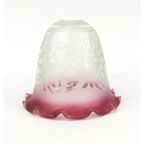 699 - Cranberry and clear glass shade etched with stylised flowers, 19cm high