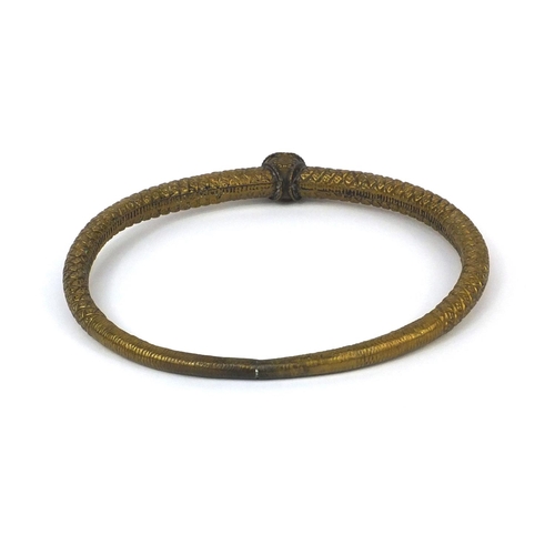 646 - Middle Eastern brass torc, 19.5cm in length