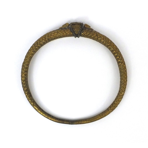 646 - Middle Eastern brass torc, 19.5cm in length