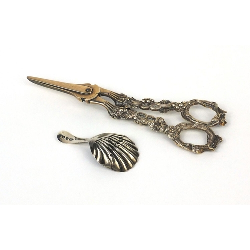 849 - Pair of Victorian silver grape scissors with grapevine handles and a Georgian silver caddy spoon wit... 