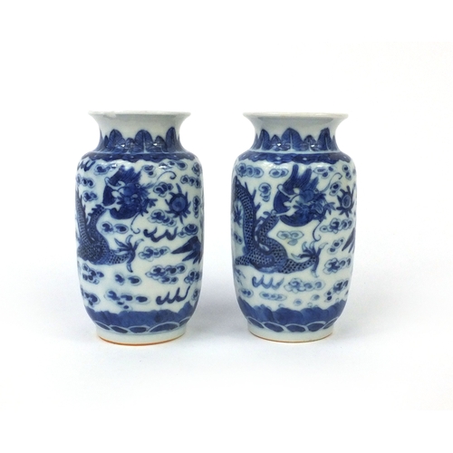 501 - Pair of Chinese blue and white porcelain vases, both hand painted with phoenixes and dragons chasing... 