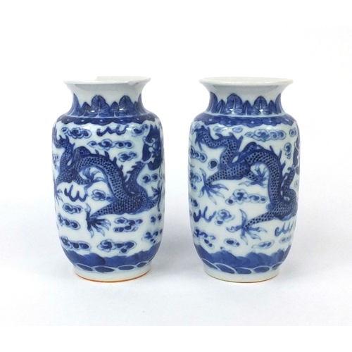 501 - Pair of Chinese blue and white porcelain vases, both hand painted with phoenixes and dragons chasing... 