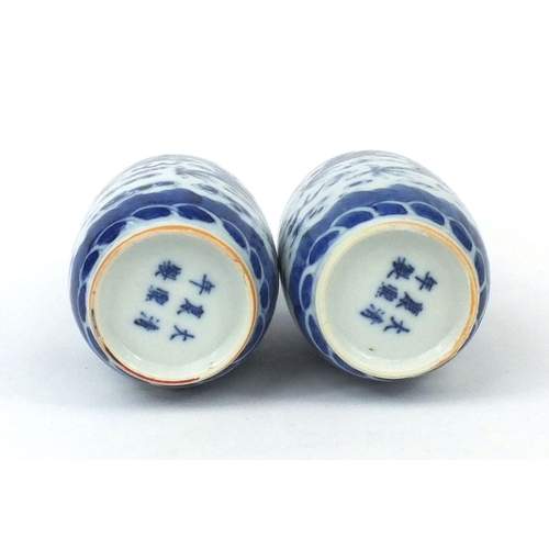 501 - Pair of Chinese blue and white porcelain vases, both hand painted with phoenixes and dragons chasing... 