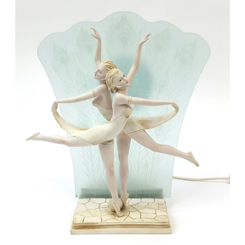 204 - Figural table lamp modelled as two Art Deco dancers with peacock feather glass back, 44cm high