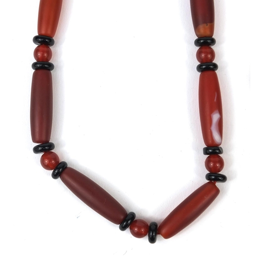 361 - Assorted jewellery comprising an amber coloured necklace, red glass bead necklace and a pendant