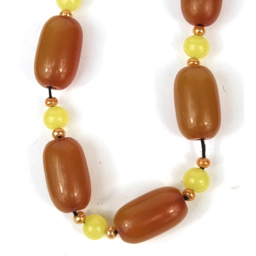 361 - Assorted jewellery comprising an amber coloured necklace, red glass bead necklace and a pendant